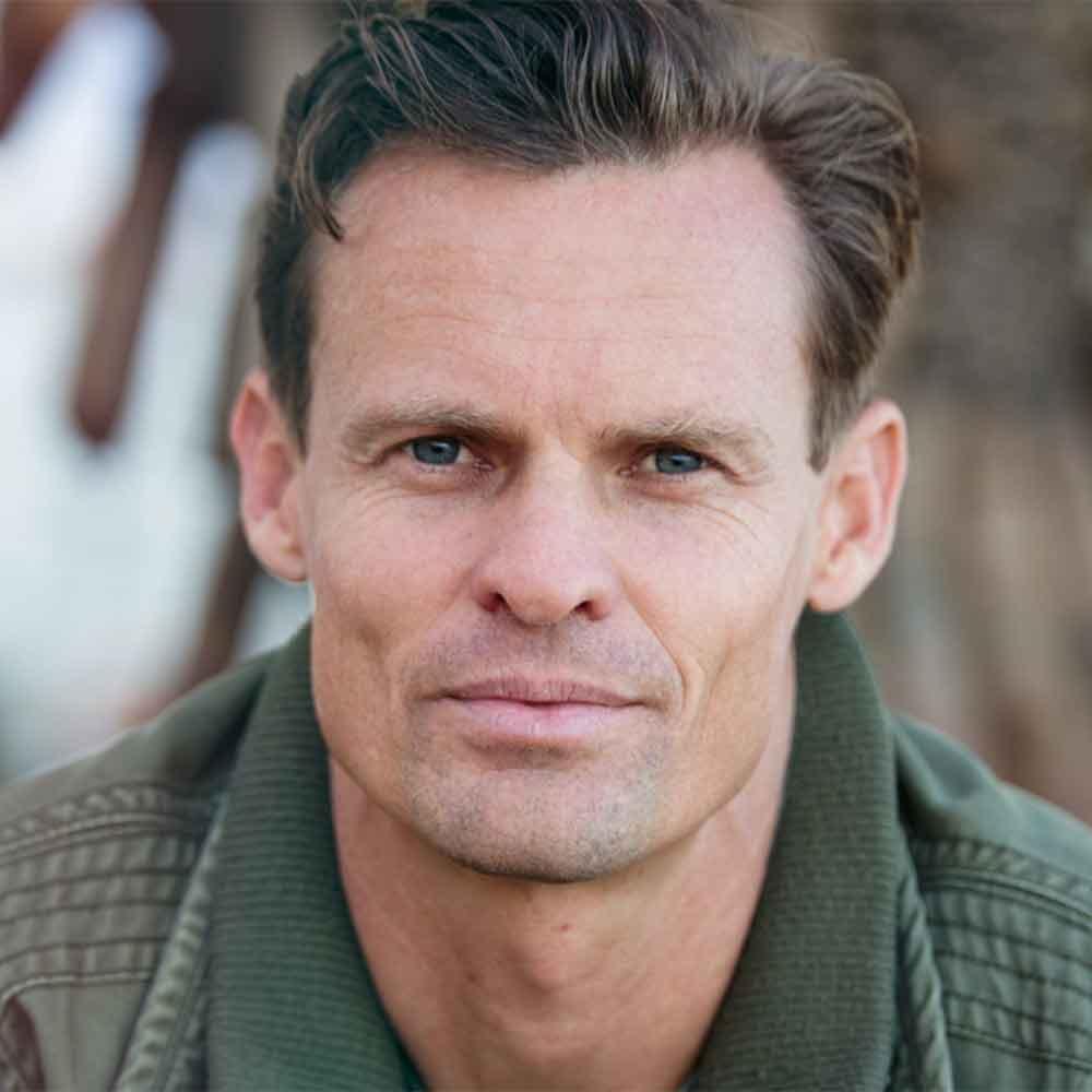 Image of a man looking directly into the camera with a neutral face.